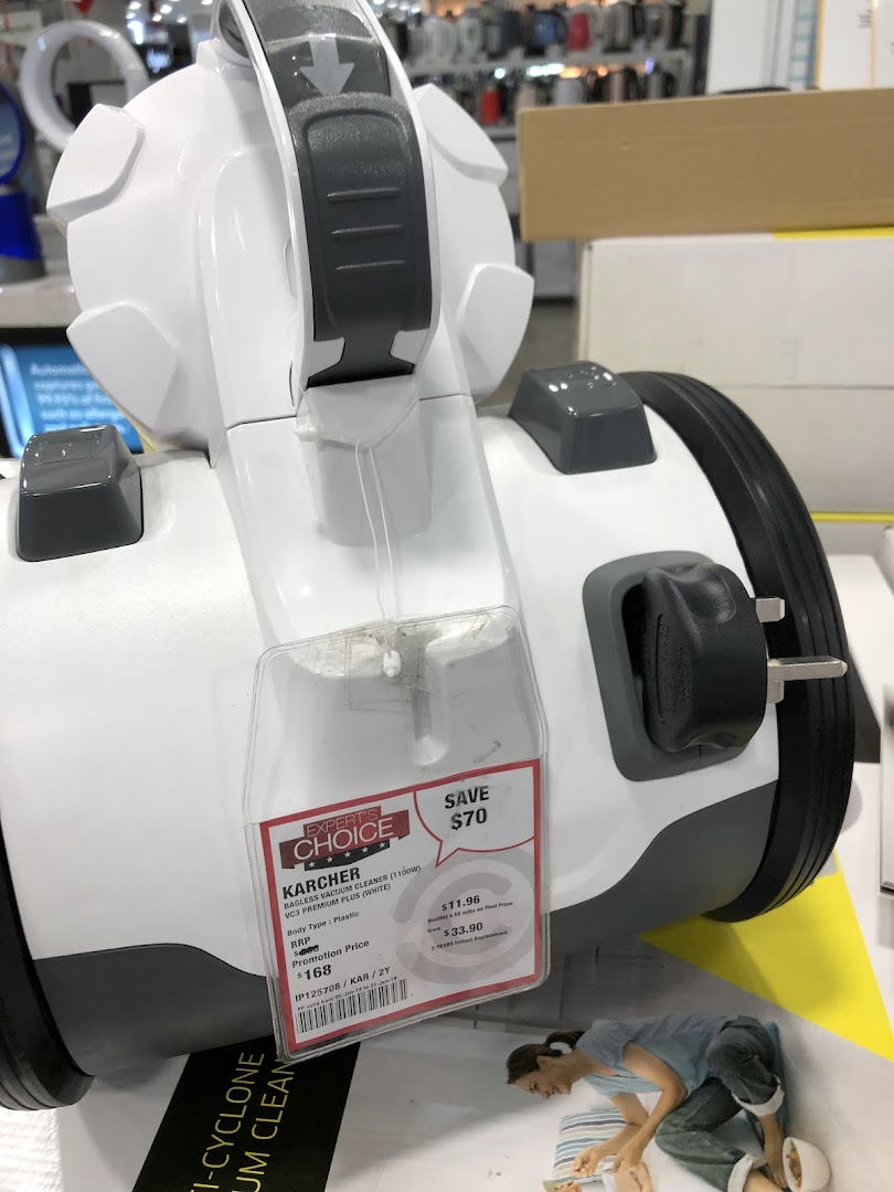 A Karcher bagless vacuum cleaner with a price tag displayed in a Courts store.