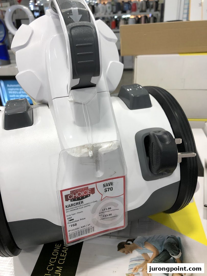 A Karcher bagless vacuum cleaner with a price tag displayed in a Courts store.