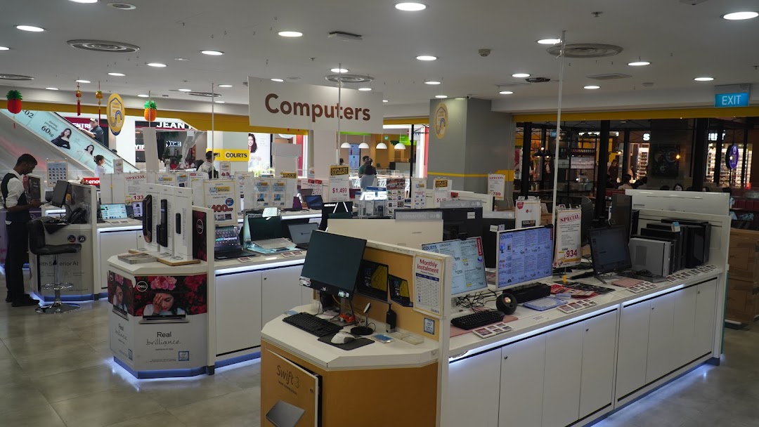 An interior view of COURTS electronics store, showcasing a wide range of computers and related products.