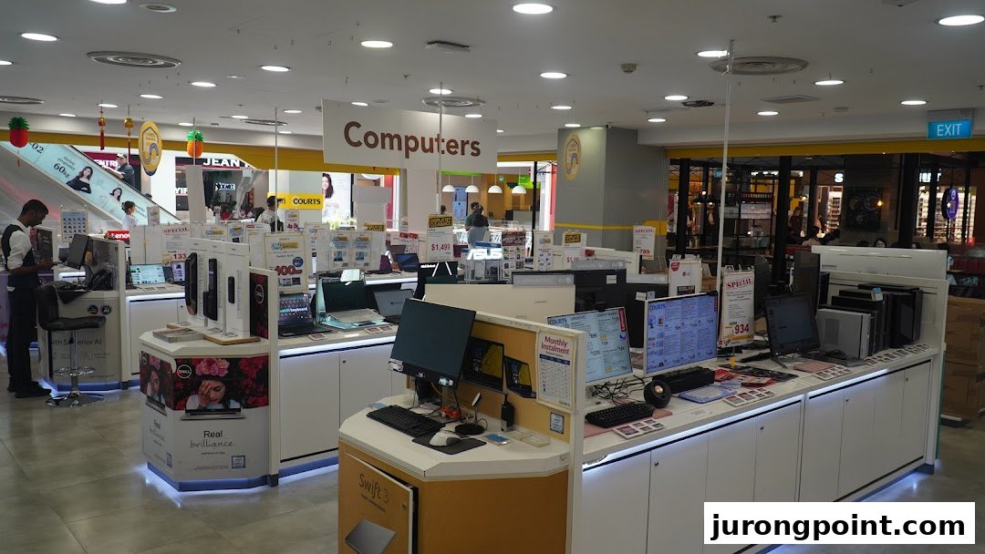 An interior view of COURTS electronics store, showcasing a wide range of computers and related products.