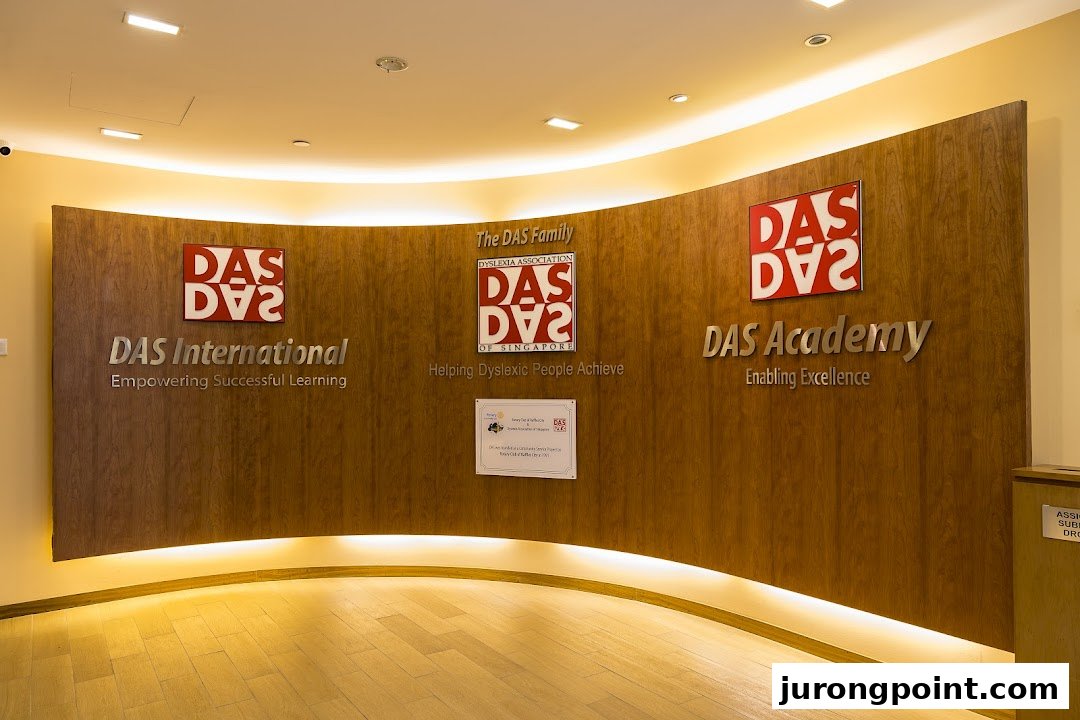 An interior view of DAS International's reception area, featuring a curved wooden wall with brand logos and mission statements.