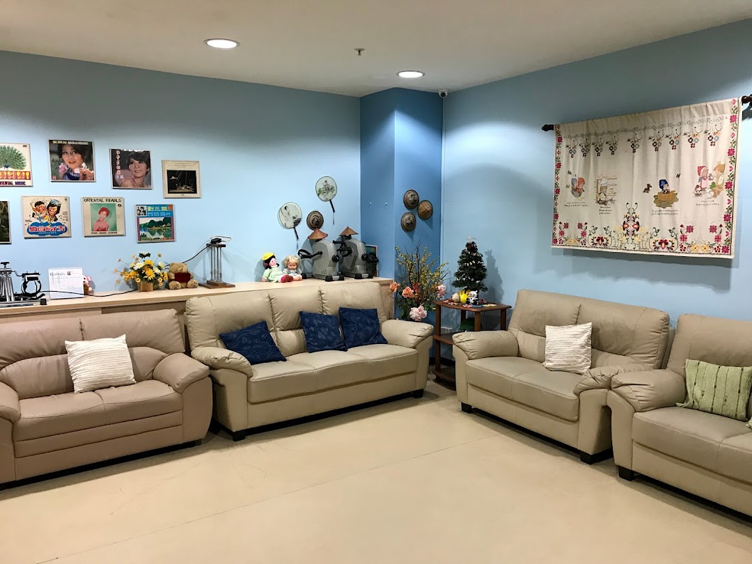 A comfortable and inviting lounge area with sofas, decorative items, and a light blue wall.