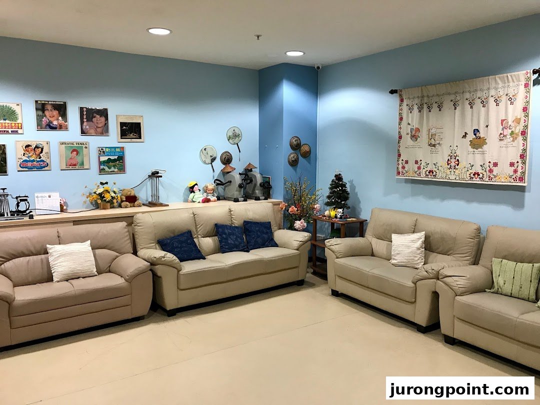 A comfortable and inviting lounge area with sofas, decorative items, and a light blue wall.