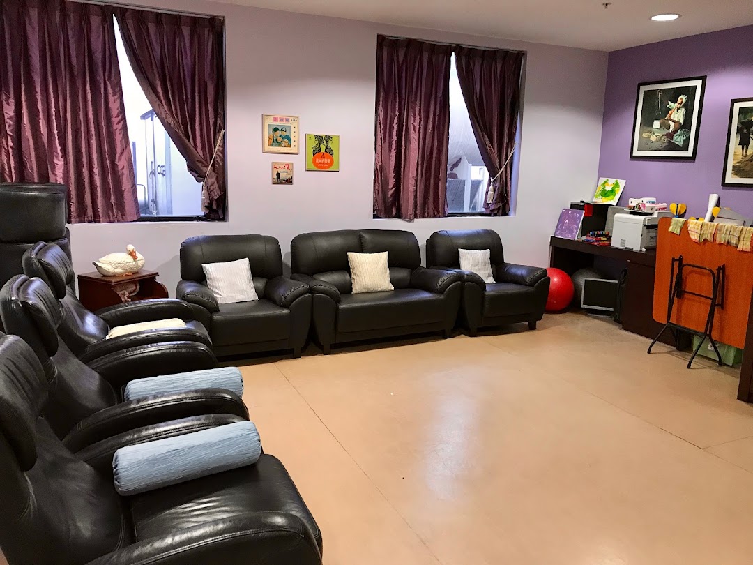 A comfortable lounge area with various seating, including recliners and sofas, in a supportive center.