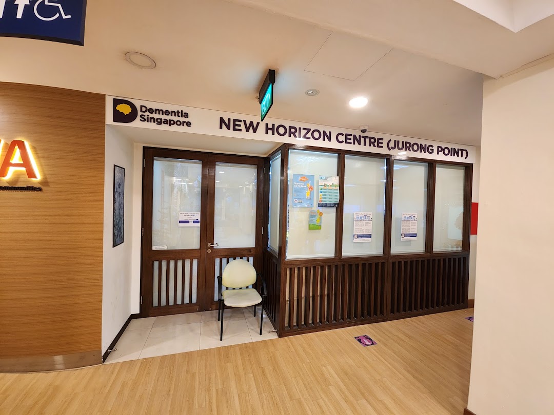 The entrance of Dementia Singapore's New Horizon Centre at Jurong Point, featuring a wooden facade and glass panels.