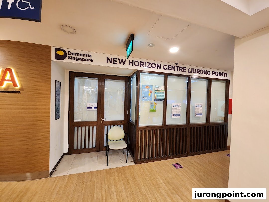 The entrance of Dementia Singapore's New Horizon Centre at Jurong Point, featuring a wooden facade and glass panels.