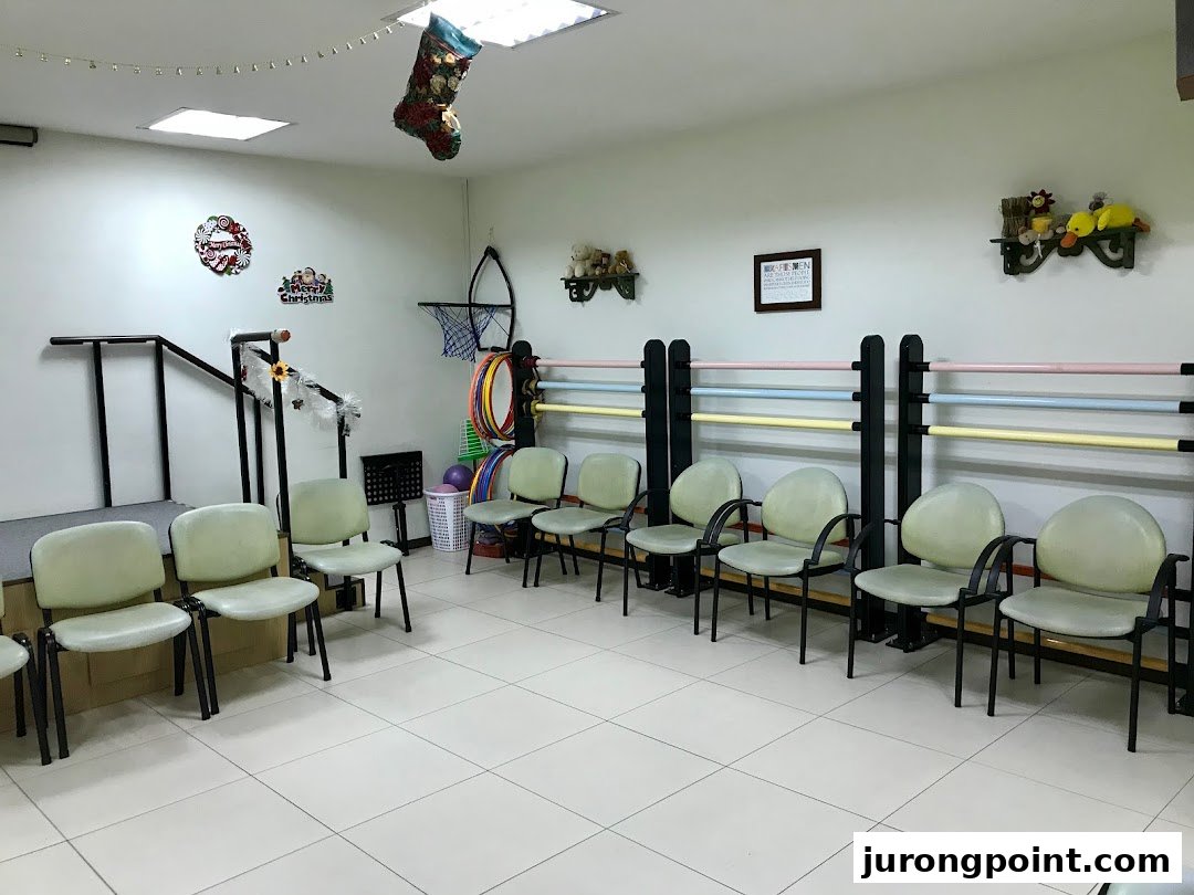 An interior view of a therapy or activity room with chairs, rehabilitation equipment, and festive decorations.
