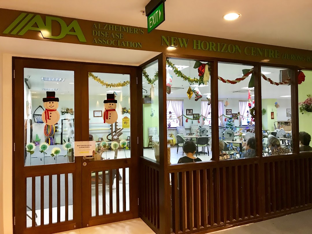 The entrance and interior of Dementia Singapore's New Horizon Centre, decorated with festive snowman cutouts and garlands.