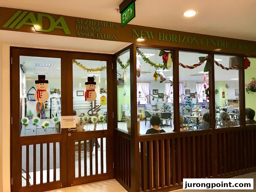 The entrance and interior of Dementia Singapore's New Horizon Centre, decorated with festive snowman cutouts and garlands.