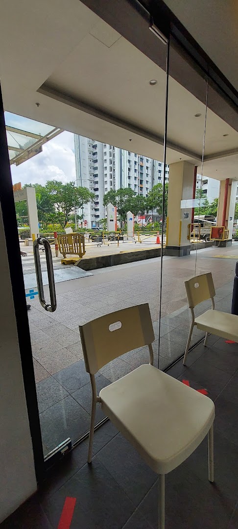 View from inside DentalTrendz Boon Lay, showing a waiting area with chairs and the outdoor surroundings.