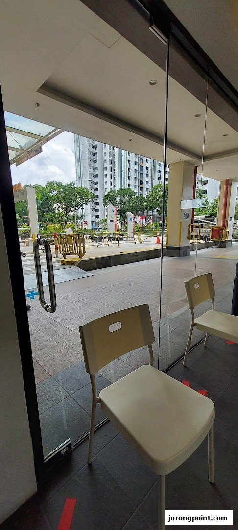 View from inside DentalTrendz Boon Lay, showing a waiting area with chairs and the outdoor surroundings.