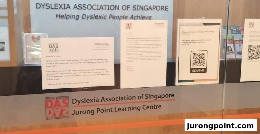 The glass entrance of the Dyslexia Association of Singapore Learning Centre with informational notices.