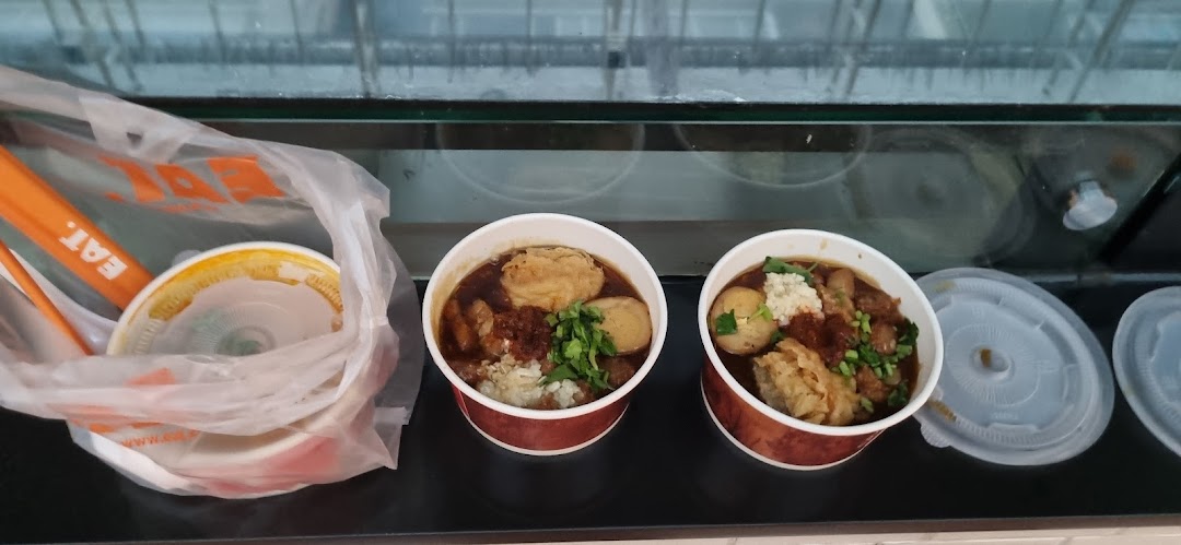 Two bowls of delicious-looking food, possibly noodles or stew, from EAT. ready for takeaway.