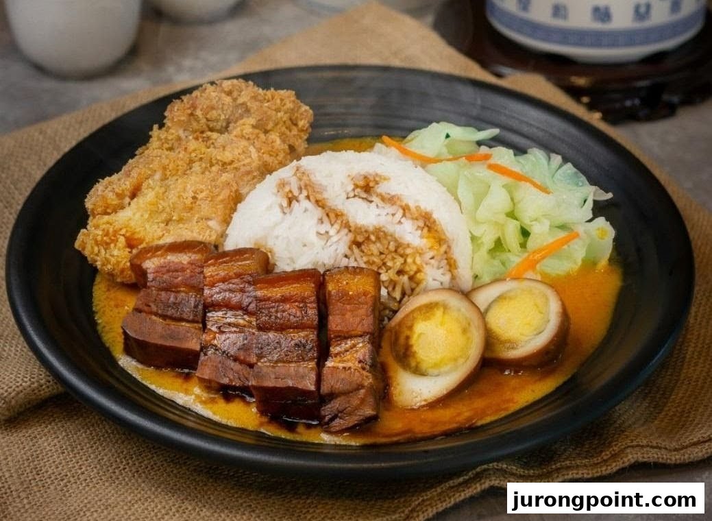 A delicious plate featuring rice, braised pork belly, fried chicken, braised eggs, and fresh cabbage.