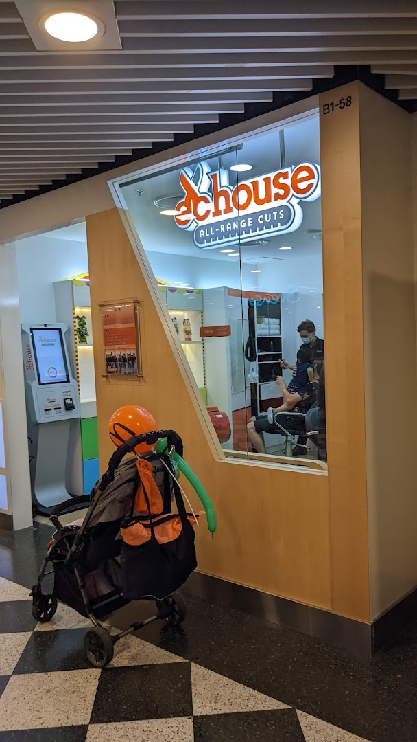 The EC House shop front features its 'ALL-RANGE CUTS' logo, a self-service kiosk, and a stylist attending to a child inside.