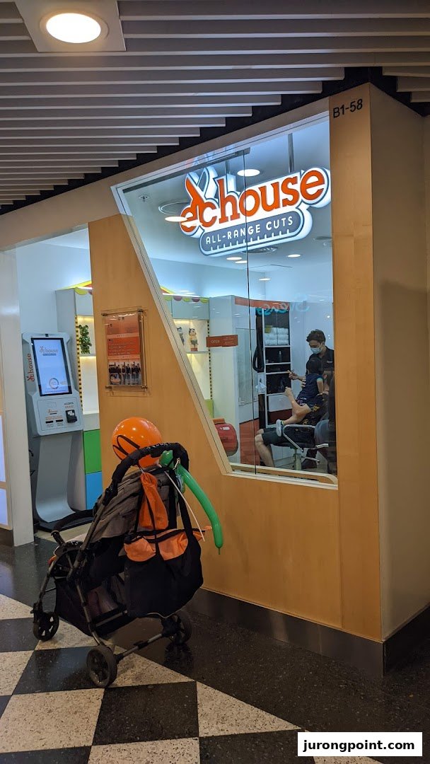 The EC House shop front features its 'ALL-RANGE CUTS' logo, a self-service kiosk, and a stylist attending to a child inside.