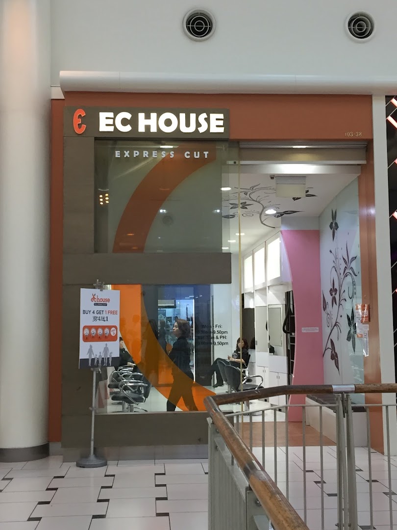 The storefront of EC House, an express cut hair salon, featuring its bright signage.