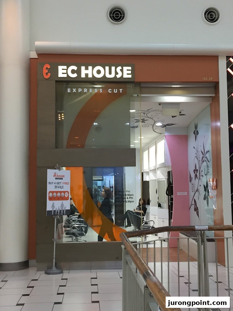 The storefront of EC House, an express cut hair salon, featuring its bright signage.