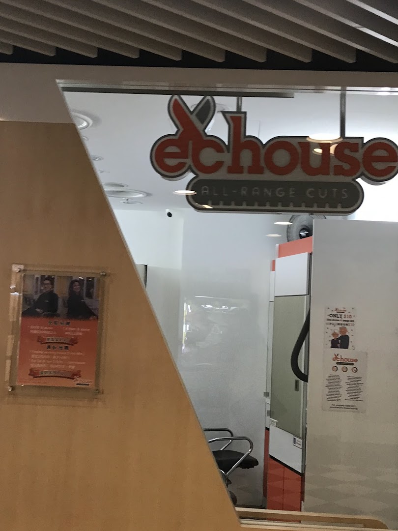 The shopfront of EC House, a hair salon, featuring its logo and entrance.