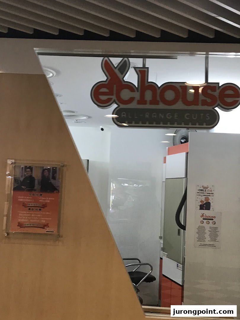 The shopfront of EC House, a hair salon, featuring its logo and entrance.