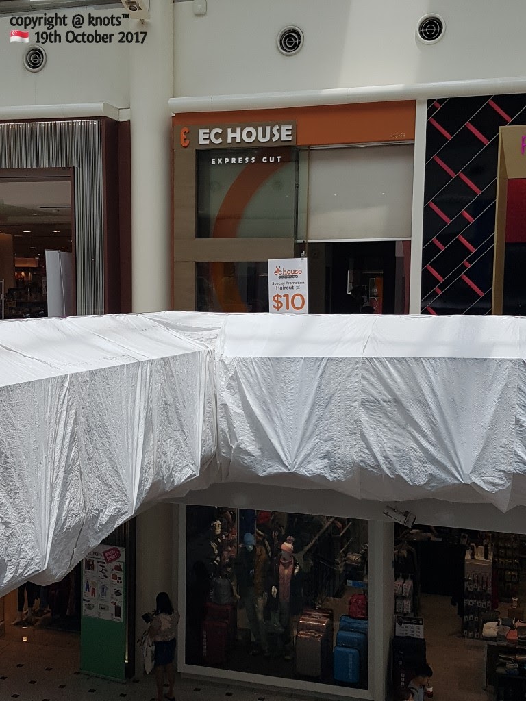 The storefront of EC House Express Cut, featuring a $10 haircut promotion sign.
