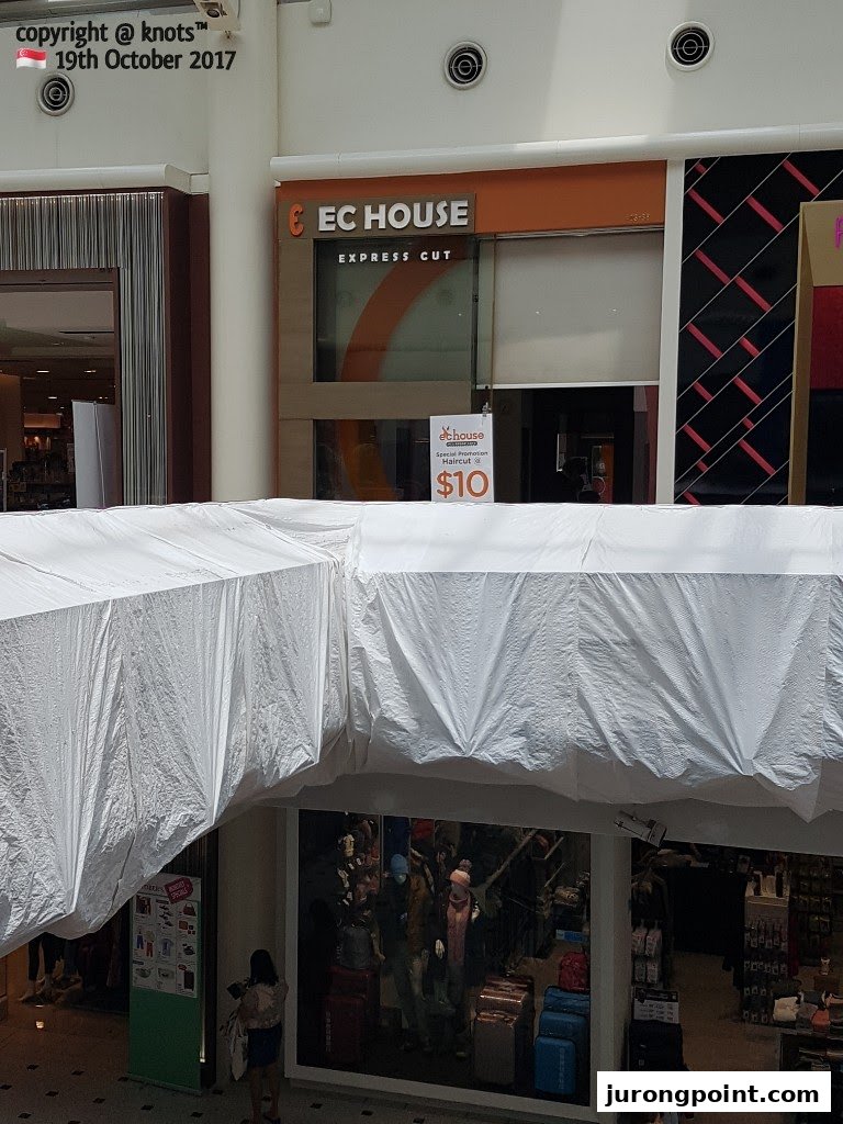 The storefront of EC House Express Cut, featuring a $10 haircut promotion sign.