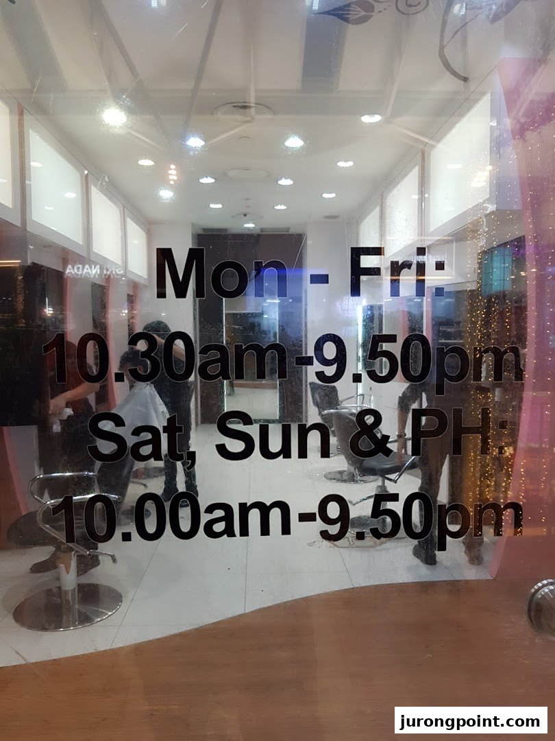 View of EC House salon interior through its glass door, displaying operating hours clearly.