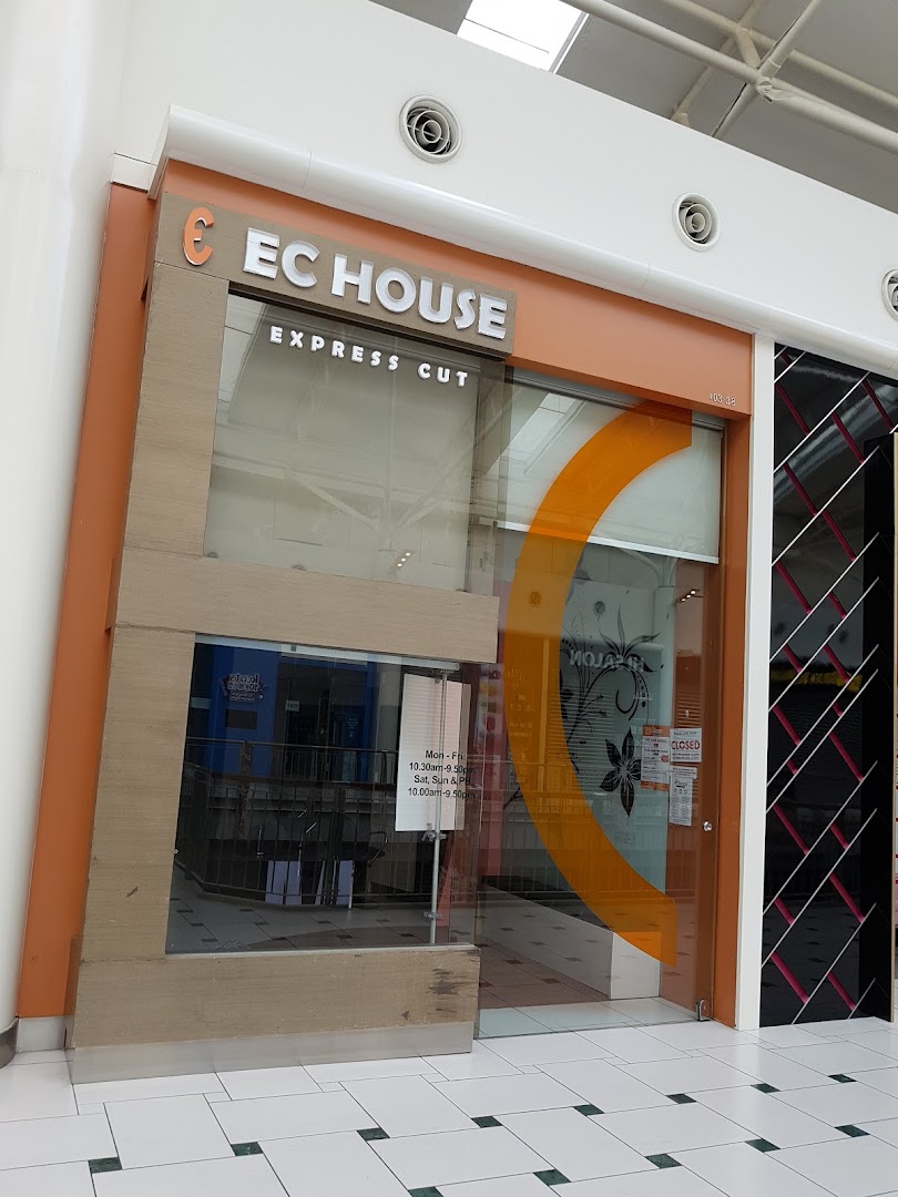 The storefront of EC House Express Cut, a hair salon, featuring its logo and entrance.