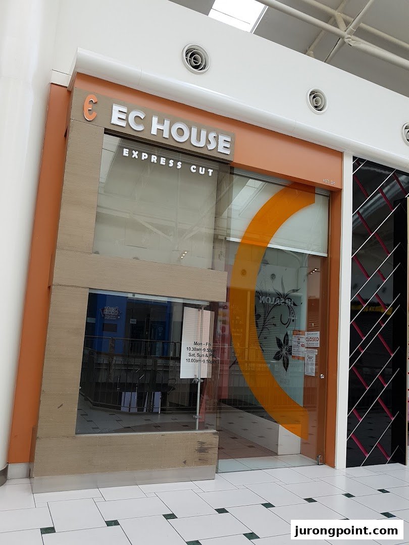The storefront of EC House Express Cut, a hair salon, featuring its logo and entrance.