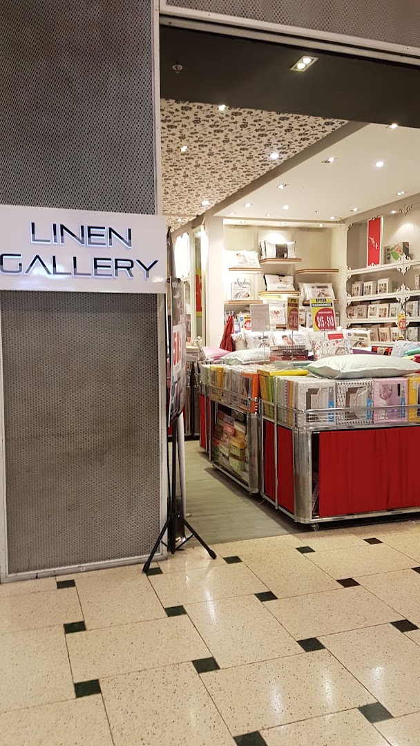 View of Epitex (Linen Gallery) shop entrance showcasing a wide array of bedding and home textiles.