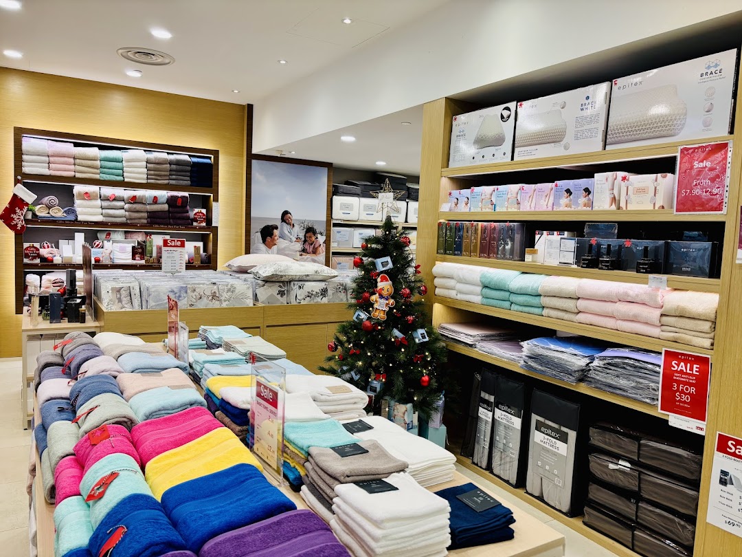 Interior view of Epitex showcasing colorful towels, bedding, pillows, and festive Christmas decorations.