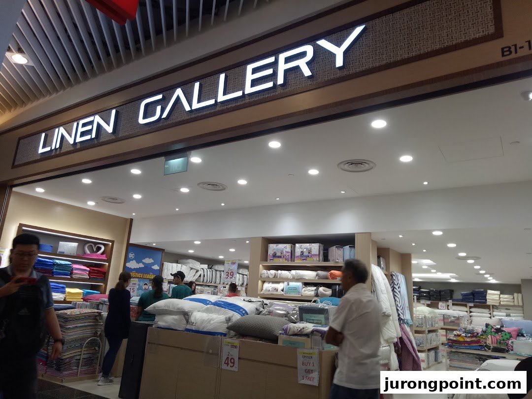 The entrance of Epitex Linen Gallery, showcasing a wide range of home linen products and customers browsing.