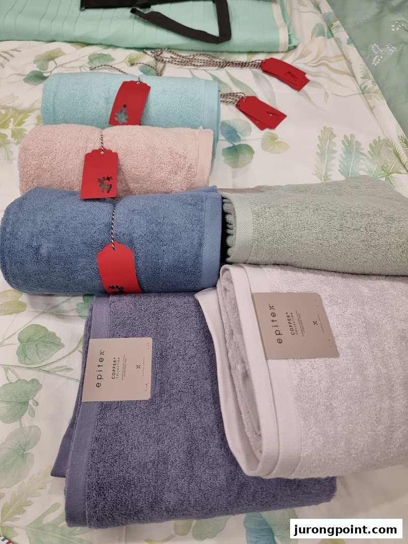 A vibrant display of Epitex towels and bedding in various colors, showcasing soft home essentials.