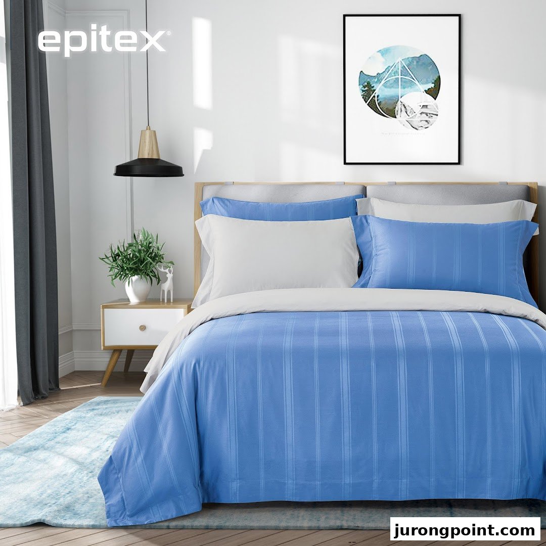 A cozy bedroom scene featuring blue and white striped bedding from Epitex, creating a serene and inviting atmosphere.