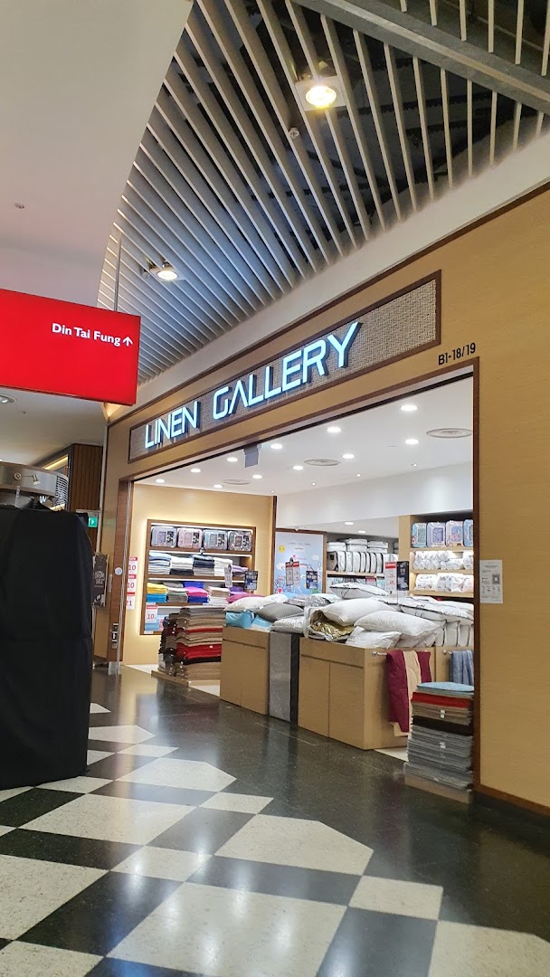 The storefront of Linen Gallery, showcasing a wide array of bedding and home textile products.