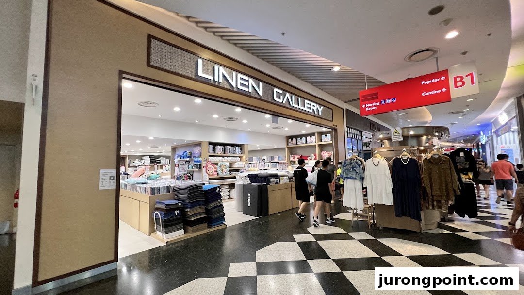 The storefront of Linen Gallery, a home linen and bedding shop, with customers inside.
