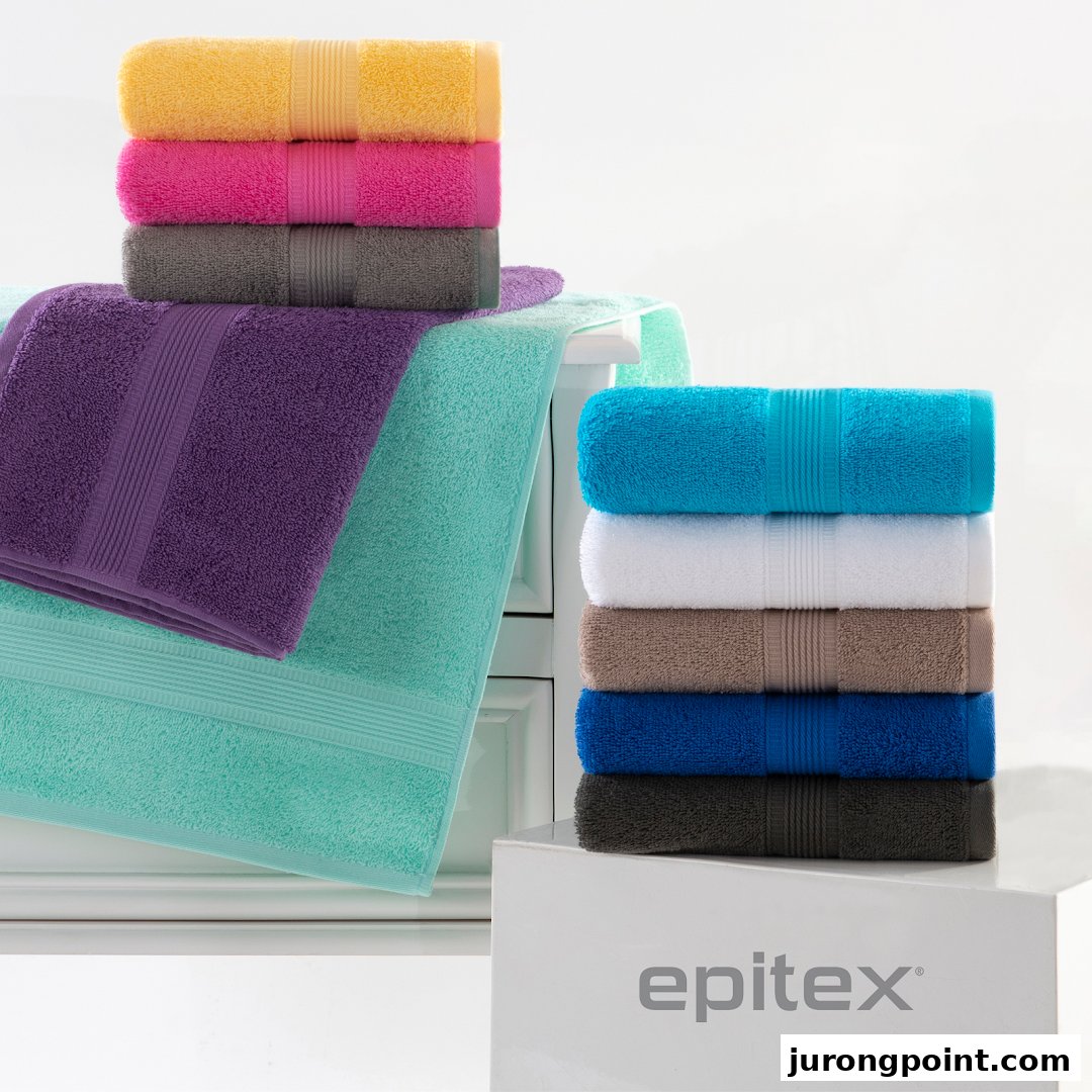 Colorful stacks of soft towels are displayed, showcasing various vibrant shades.
