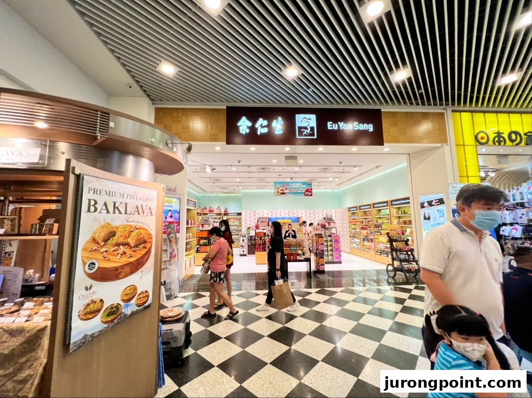 The entrance of Eu Yan Sang, a traditional Chinese medicine and health products store, with customers inside.