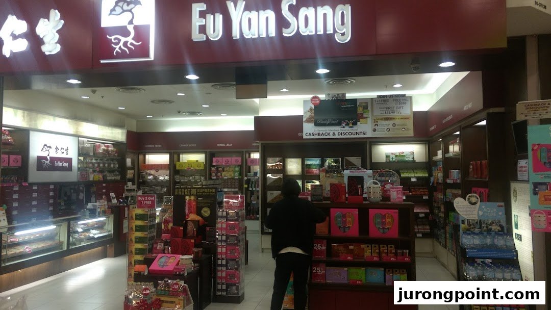 A customer browses wellness products inside the brightly lit Eu Yan Sang retail store.