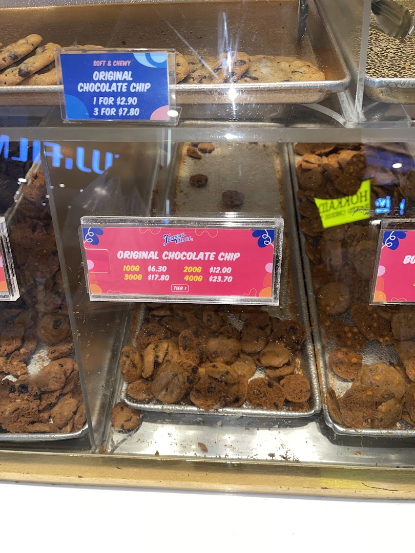 Close-up view of Famous Amos's signature chocolate chip cookies displayed with pricing information.