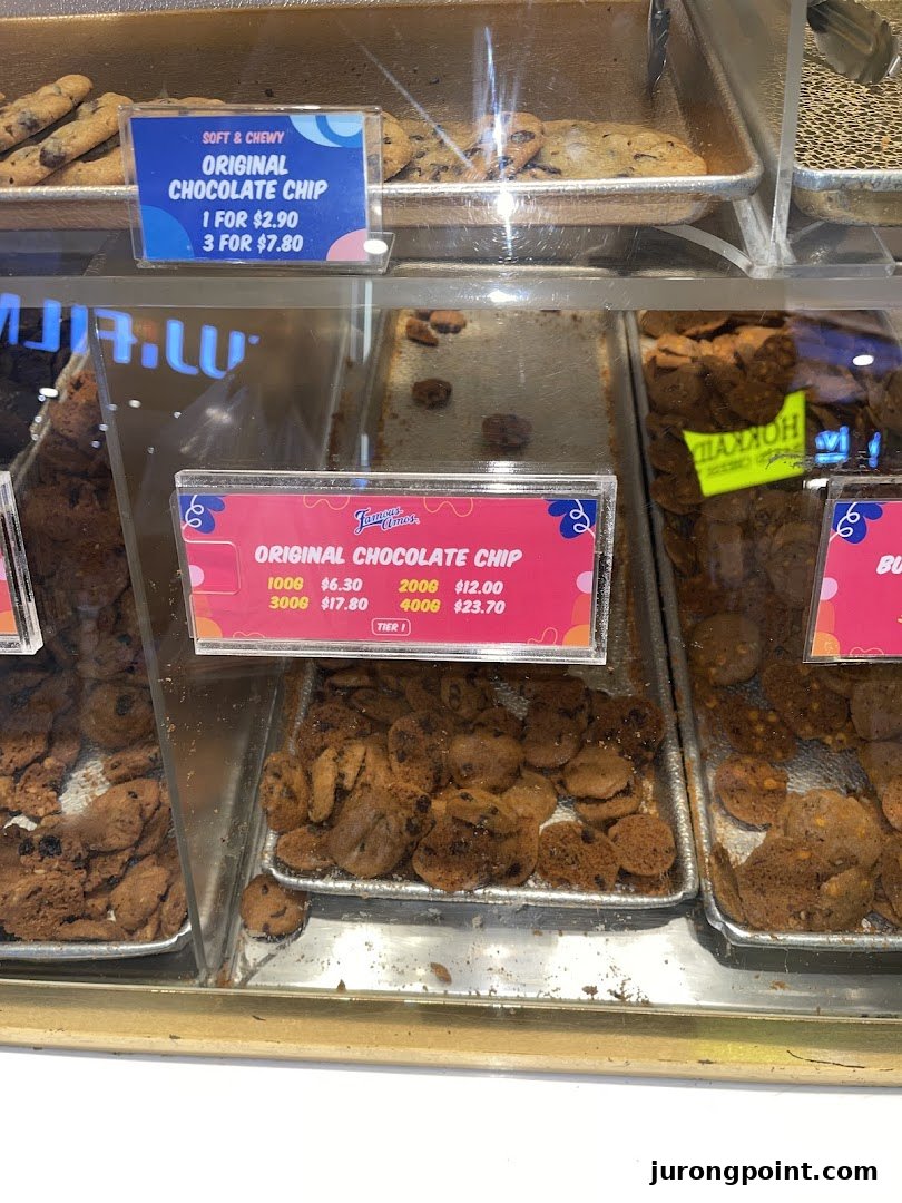 Close-up view of Famous Amos's signature chocolate chip cookies displayed with pricing information.