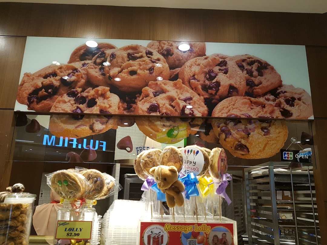 A vibrant display of Famous Amos cookies and lollipops, featuring a large graphic of chocolate chip cookies.