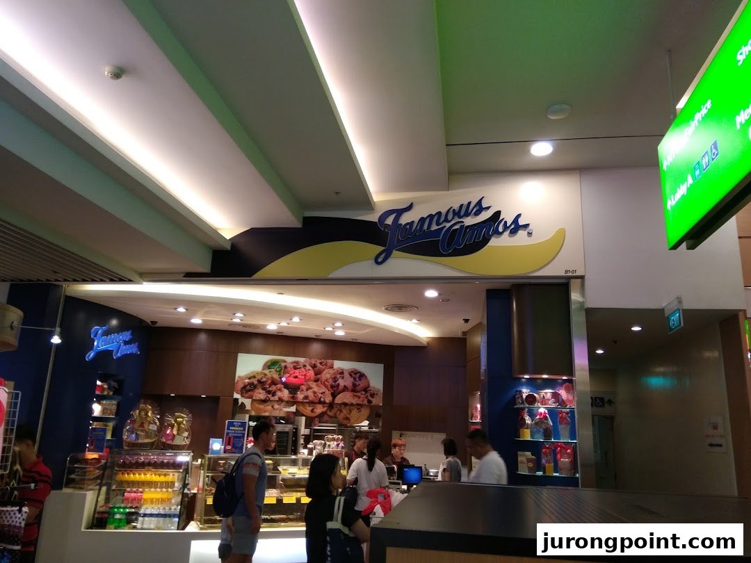 The Famous Amos shop entrance with its distinctive logo and customers inside.