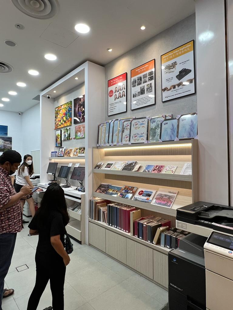Interior view of FotoHub, showcasing photo albums, prints, and customer service stations.
