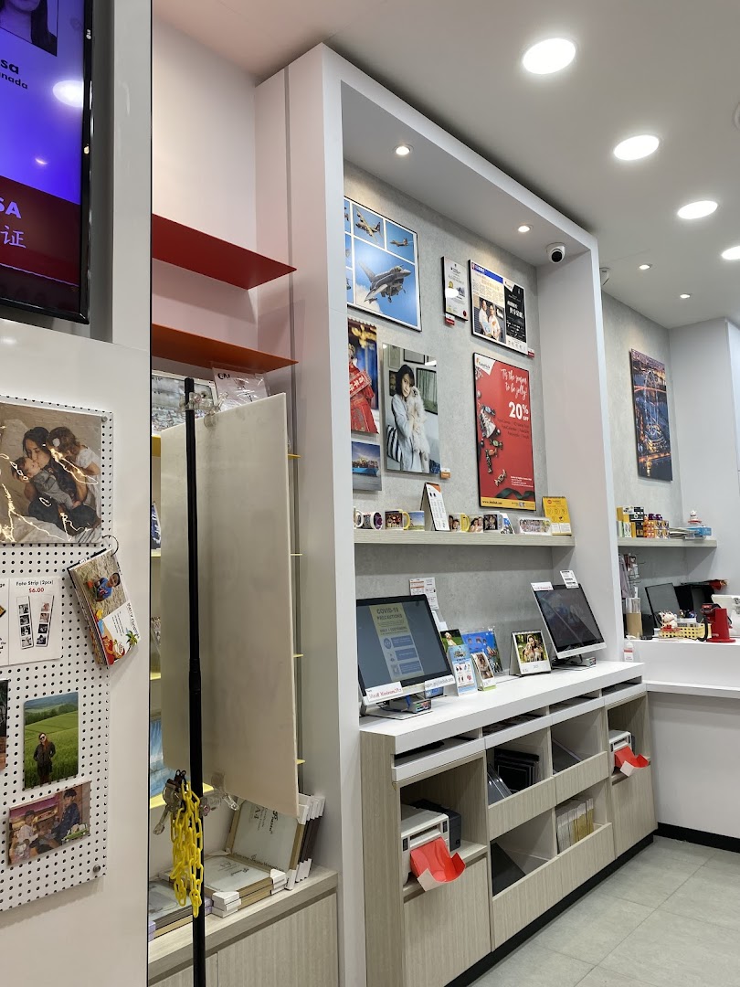 Interior view of FotoHub, showcasing photo printing kiosks, framed prints, and product displays.