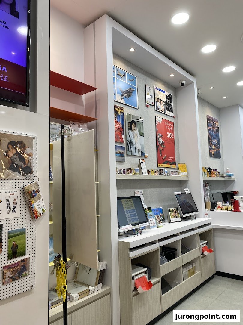 Interior view of FotoHub, showcasing photo printing kiosks, framed prints, and product displays.