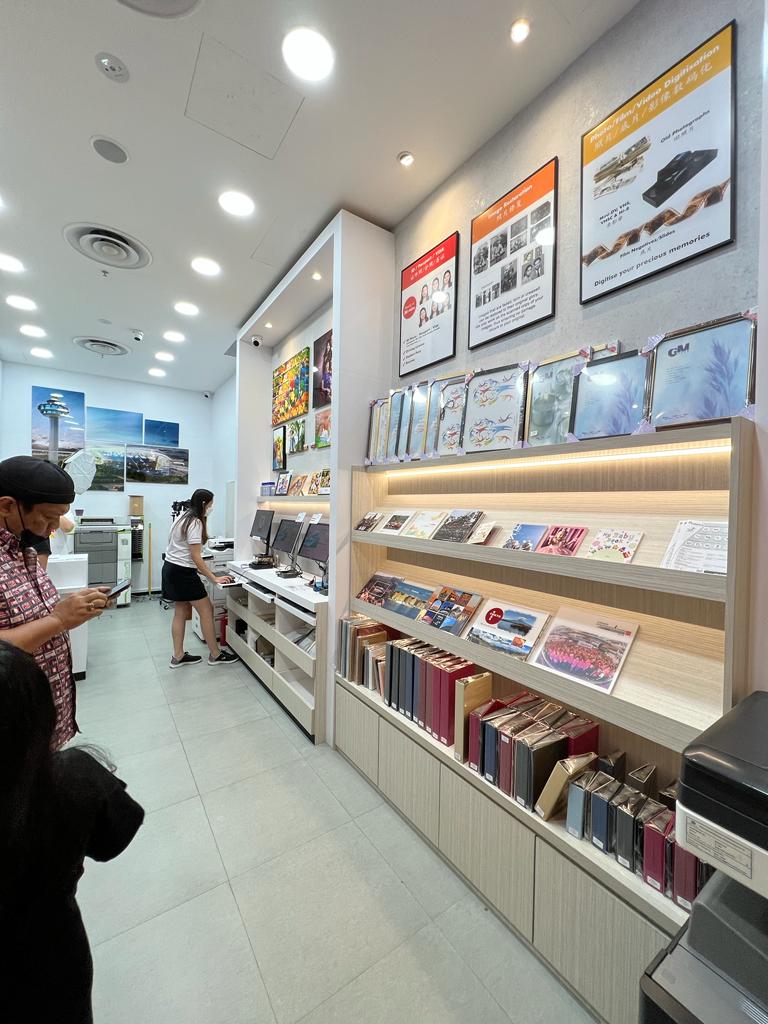 Interior view of FotoHub, showcasing photo printing services, digitization displays, and customer areas.