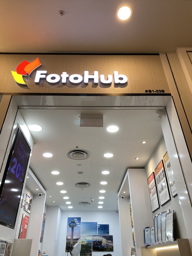 The FotoHub shop entrance showcasing its logo and a glimpse of the interior services.