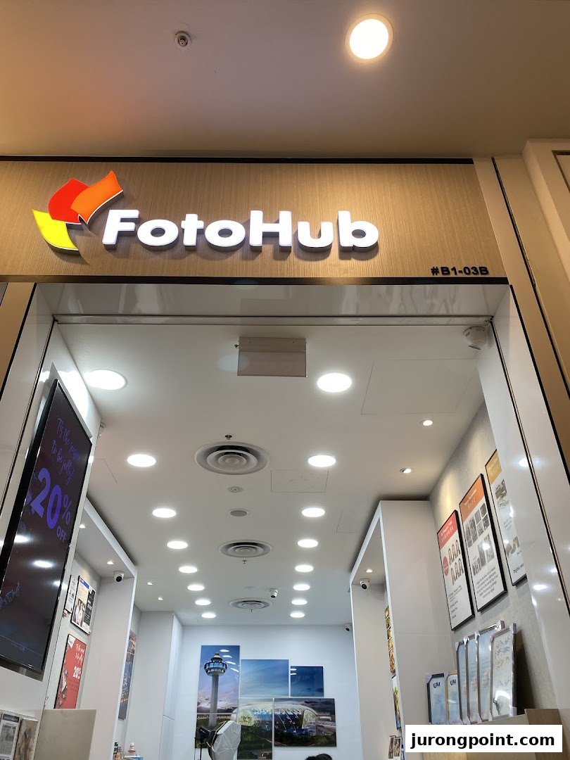 The FotoHub shop entrance showcasing its logo and a glimpse of the interior services.
