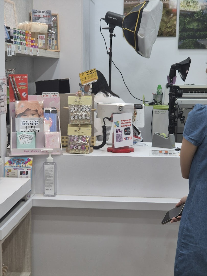 Interior view of FotoHub's counter area, displaying products, payment options, and photography equipment.